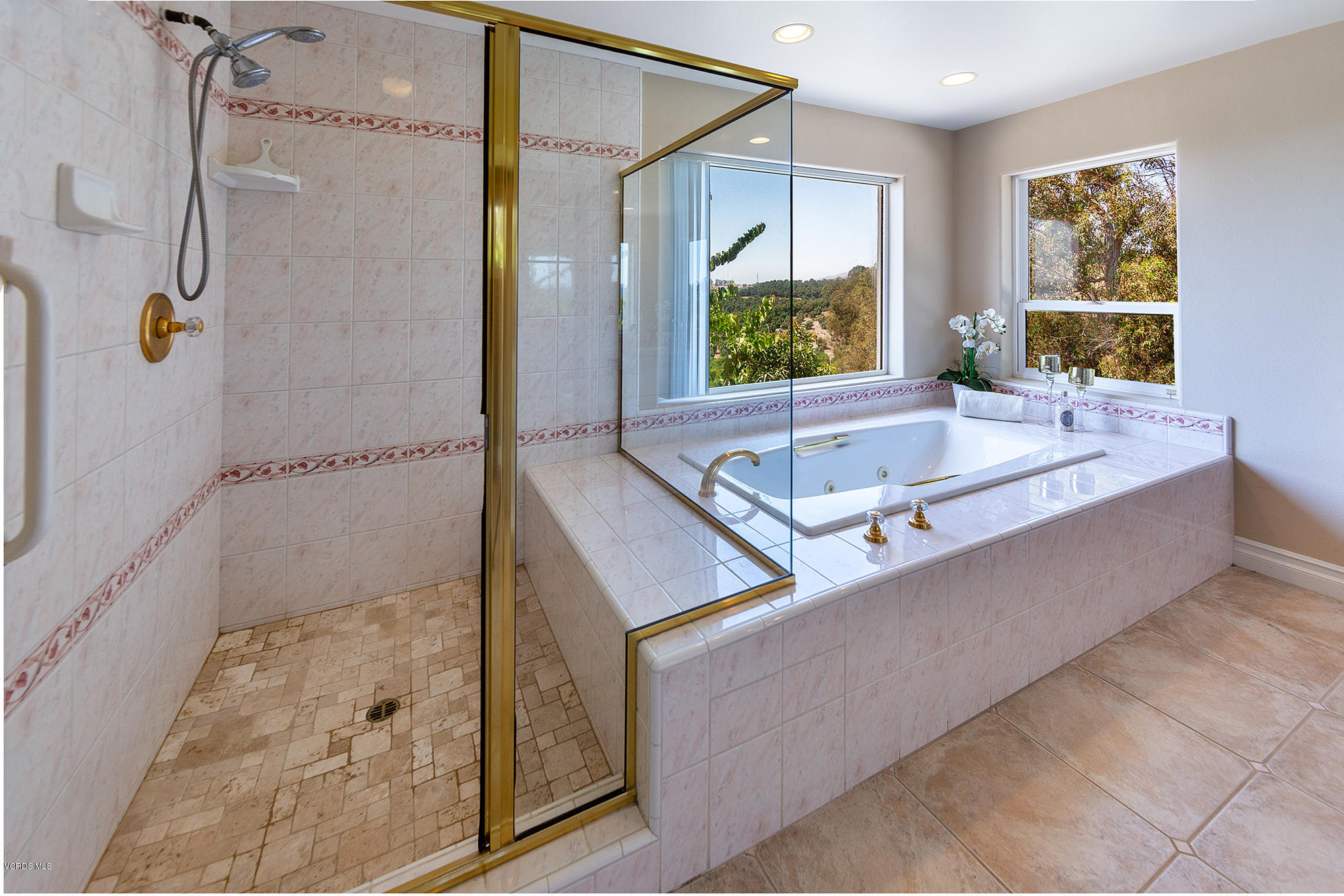 10089 Stockton Road Moorpark, CA 93021 - Photo 16 of 39 a bathroom with a tub a sink a mirror and a shower