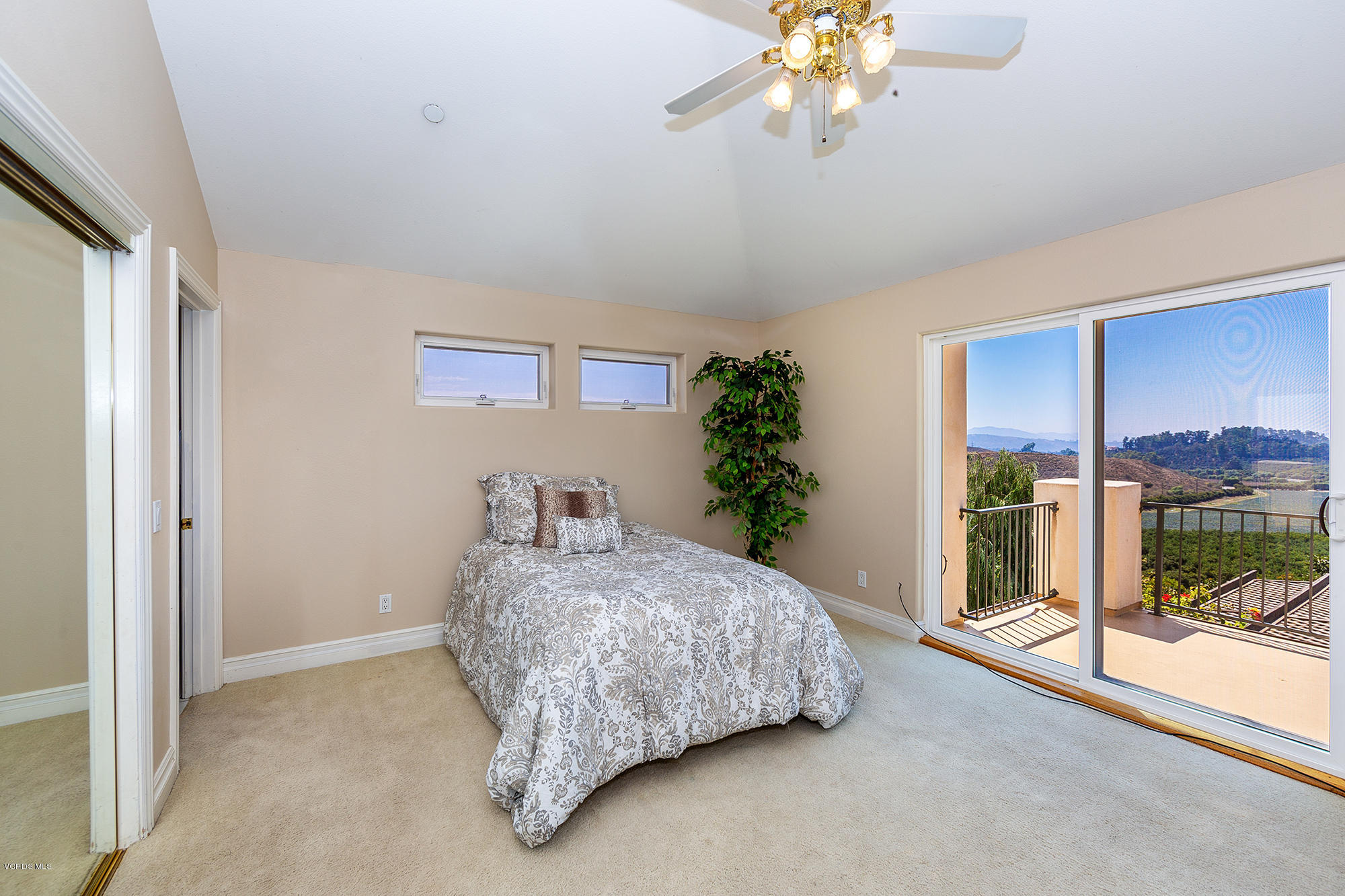 10089 Stockton Road Moorpark, CA 93021 - Photo 20 of 39 a bedroom with a large bed and a chandelier