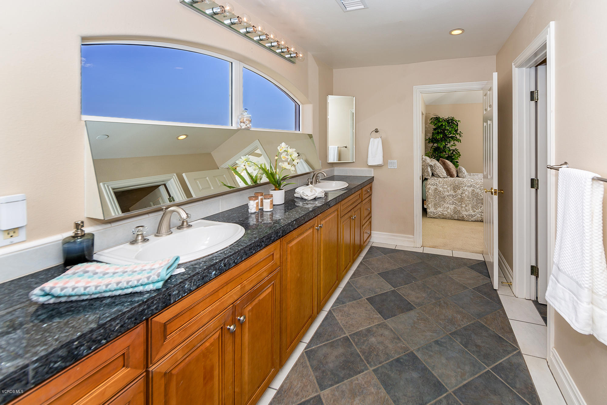 10089 Stockton Road Moorpark, CA 93021 - Photo 21 of 39 a bathroom with a granite countertop sink a mirror and a bathtub