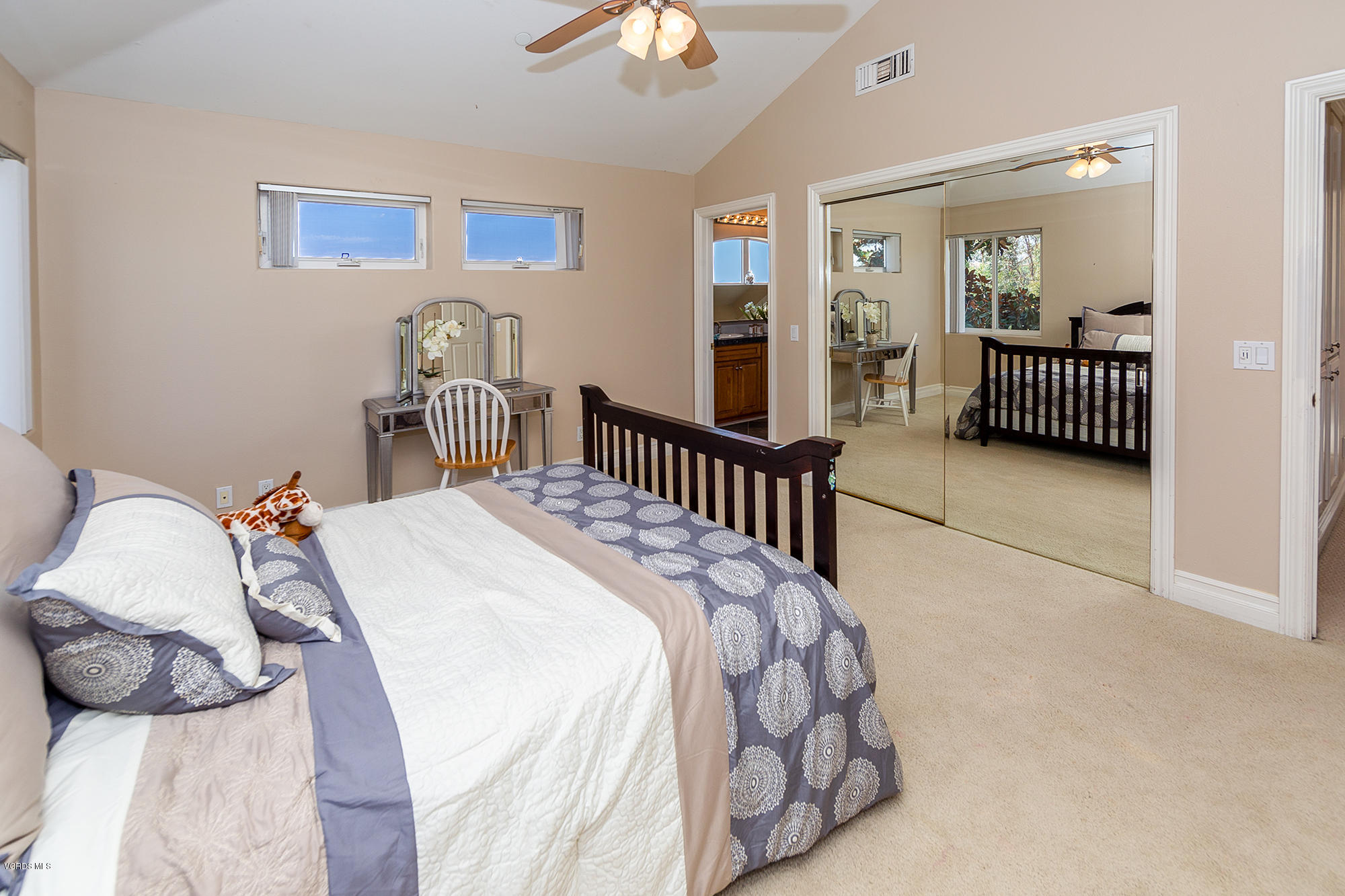 10089 Stockton Road Moorpark, CA 93021 - Photo 22 of 39 a bedroom with a bed and a chandelier