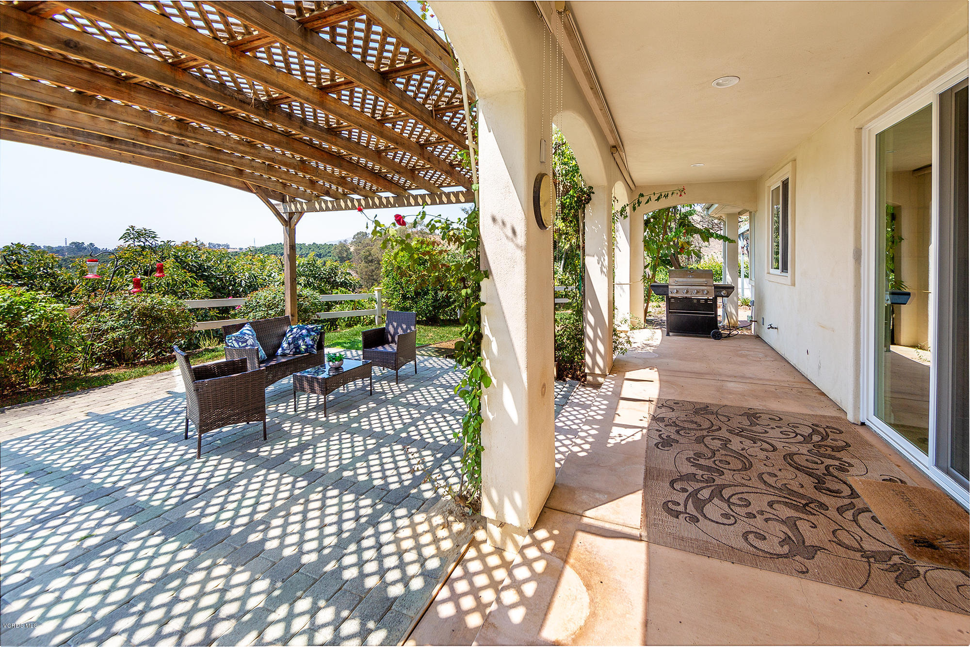 10089 Stockton Road Moorpark, CA 93021 - Photo 24 of 39 a view of a patio with a dining table and chairs with wooden floor