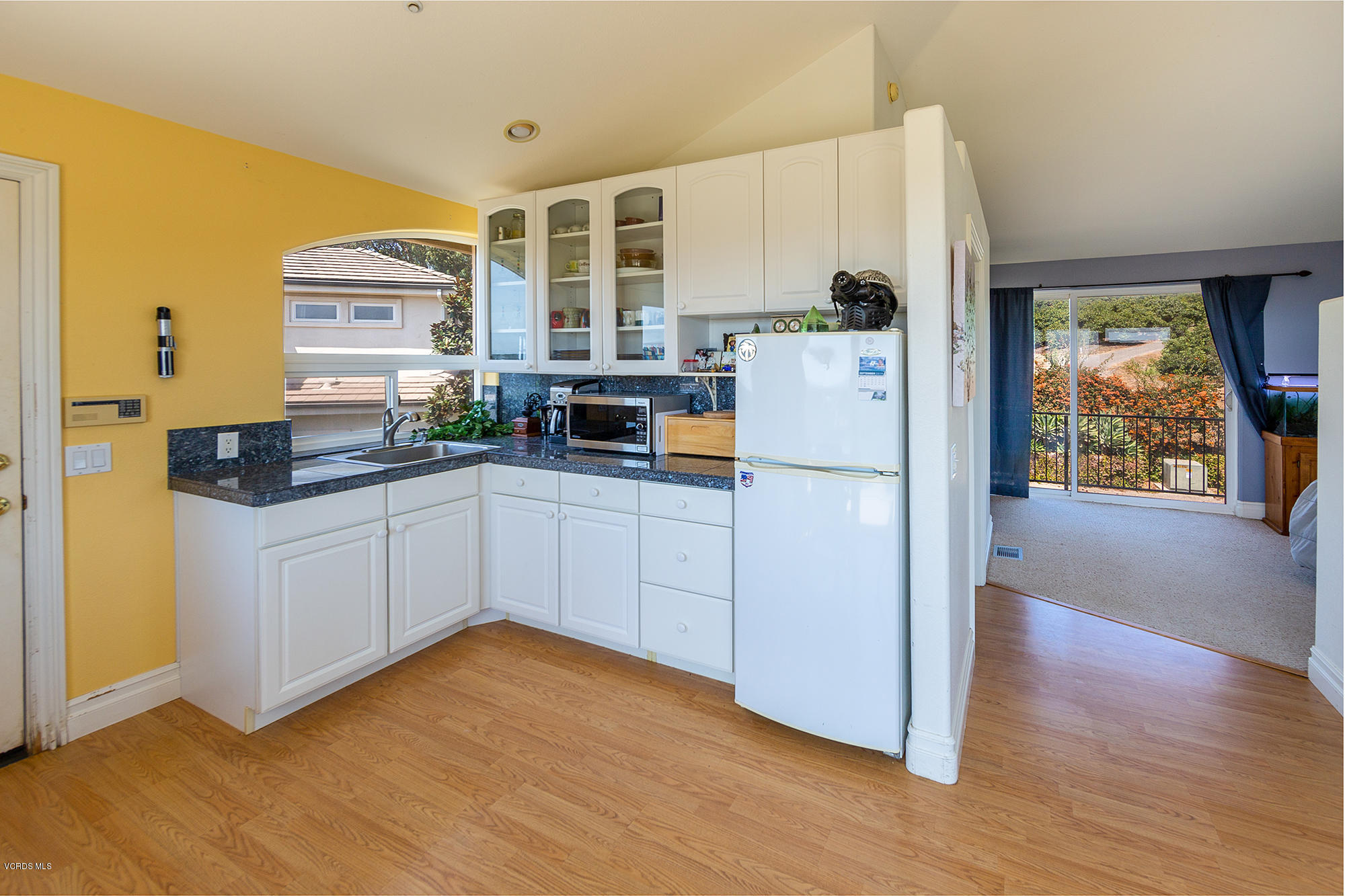 10089 Stockton Road Moorpark, CA 93021 - Photo 30 of 39 a kitchen with stainless steel appliances a refrigerator sink and cabinets