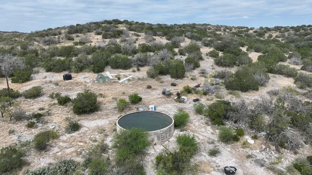 an aerial view of mountain with trees all around
