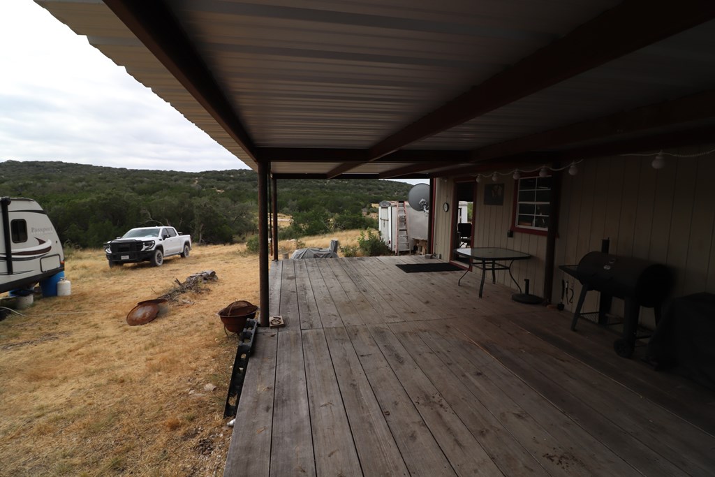 2 Sd 45682 Rocksprings, TX 78880 - Photo 71 of 72 a view of a patio with table and chairs a barbeque with wooden floor and roof