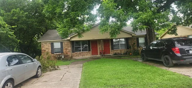 a front view of a house with a garden and porch