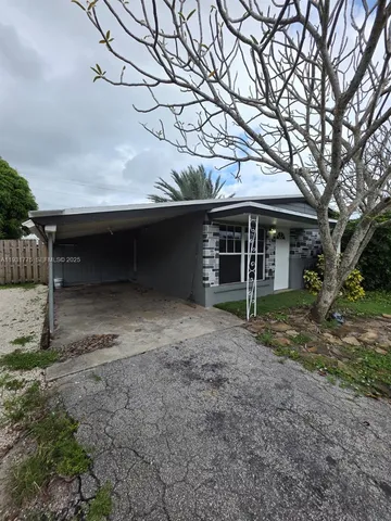 a view of house with a tree in the background