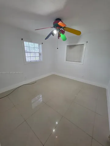 a view of a room that has a fan and a window in it