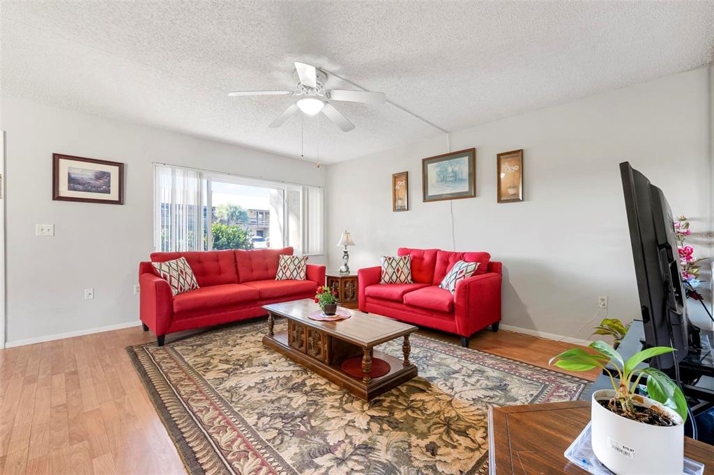 25 Quails Run Boulevard, Unit 6 Englewood, FL 34223 - Photo 12 of 31 a living room with furniture and a flat screen tv