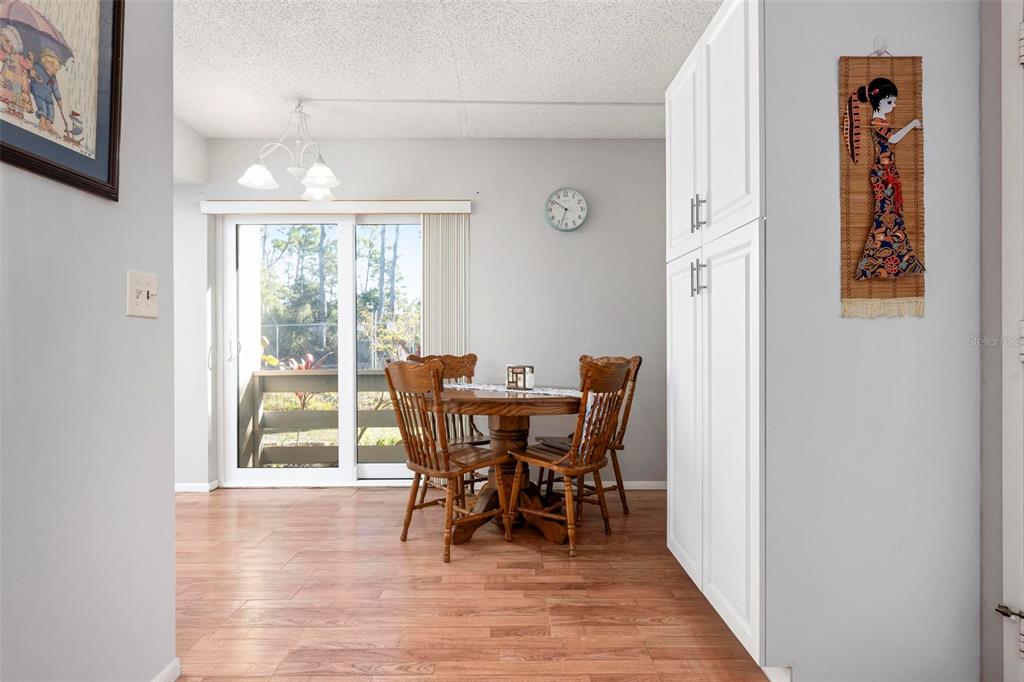 25 Quails Run Boulevard, Unit 6 Englewood, FL 34223 - Photo 14 of 31 a view of a dining room with furniture and wooden floor