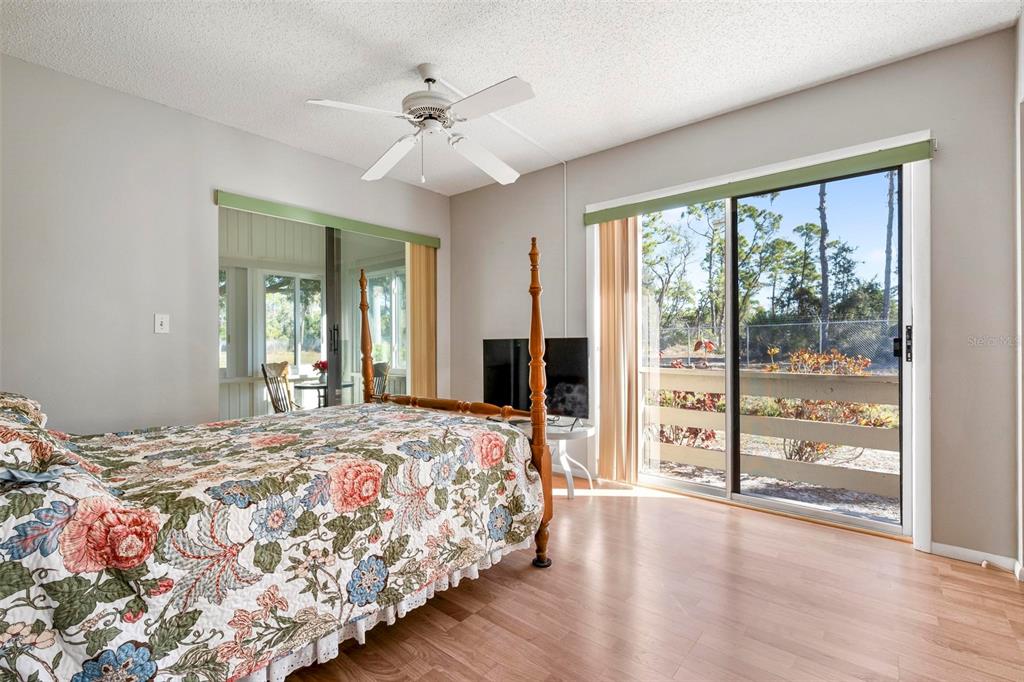 25 Quails Run Boulevard, Unit 6 Englewood, FL 34223 - Photo 19 of 31 a bedroom with bed and wooden floor