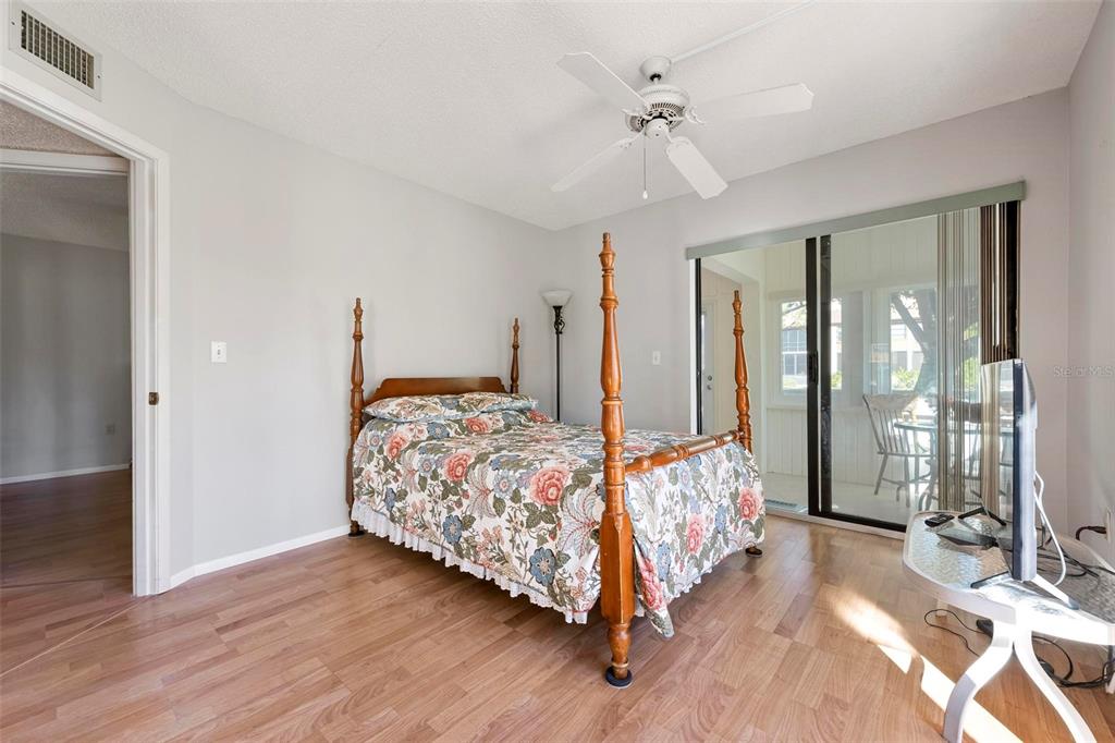 25 Quails Run Boulevard, Unit 6 Englewood, FL 34223 - Photo 20 of 31 a bedroom with a bed mirror and window