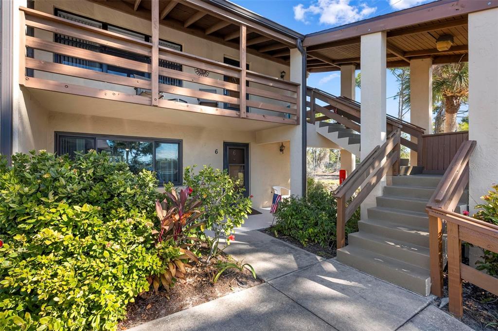25 Quails Run Boulevard, Unit 6 Englewood, FL 34223 - Photo 2 of 31 a view of a house with a flower garden