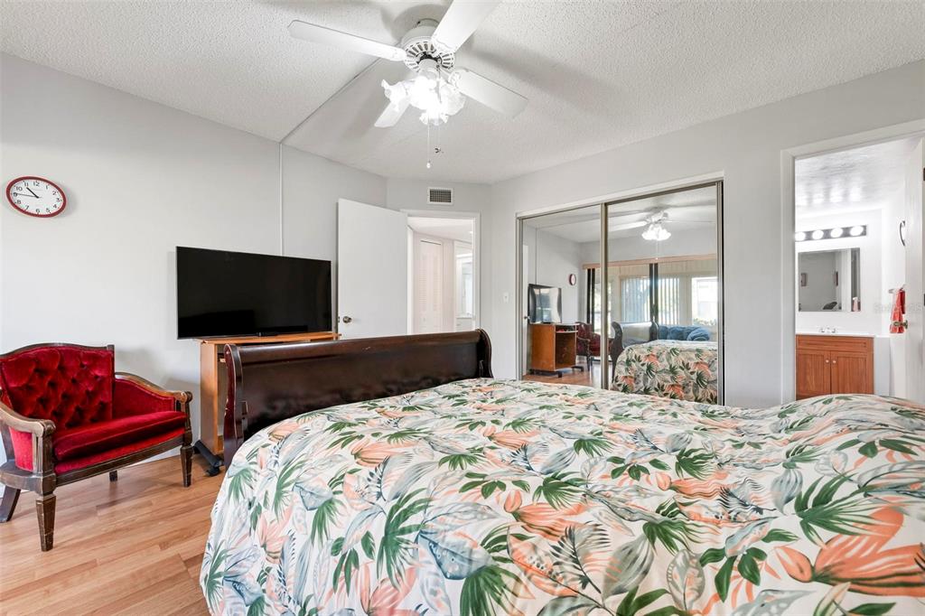 25 Quails Run Boulevard, Unit 6 Englewood, FL 34223 - Photo 24 of 31 a bedroom with a bed and a flat screen tv