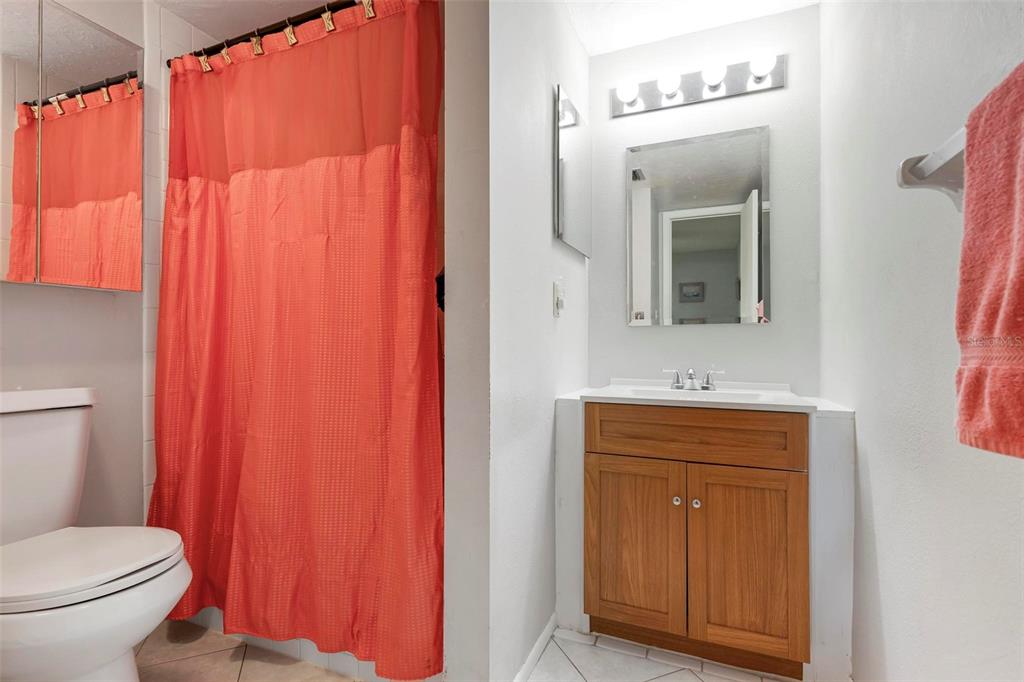 25 Quails Run Boulevard, Unit 6 Englewood, FL 34223 - Photo 26 of 31 a bathroom with a toilet a sink and mirror