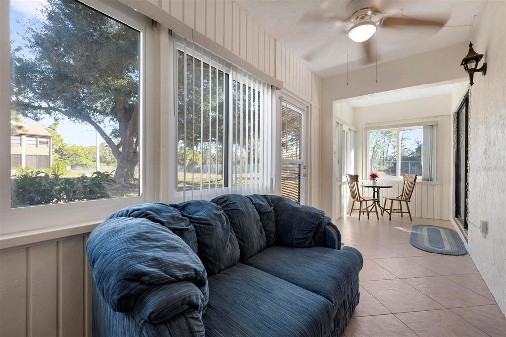 25 Quails Run Boulevard, Unit 6 Englewood, FL 34223 - Photo 27 of 31 a living room with furniture and a large window