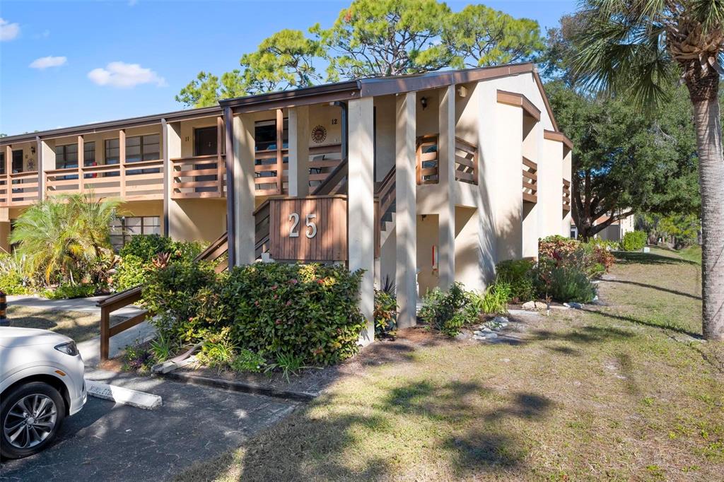 25 Quails Run Boulevard, Unit 6 Englewood, FL 34223 - Photo 3 of 31 a front view of a house with a yard