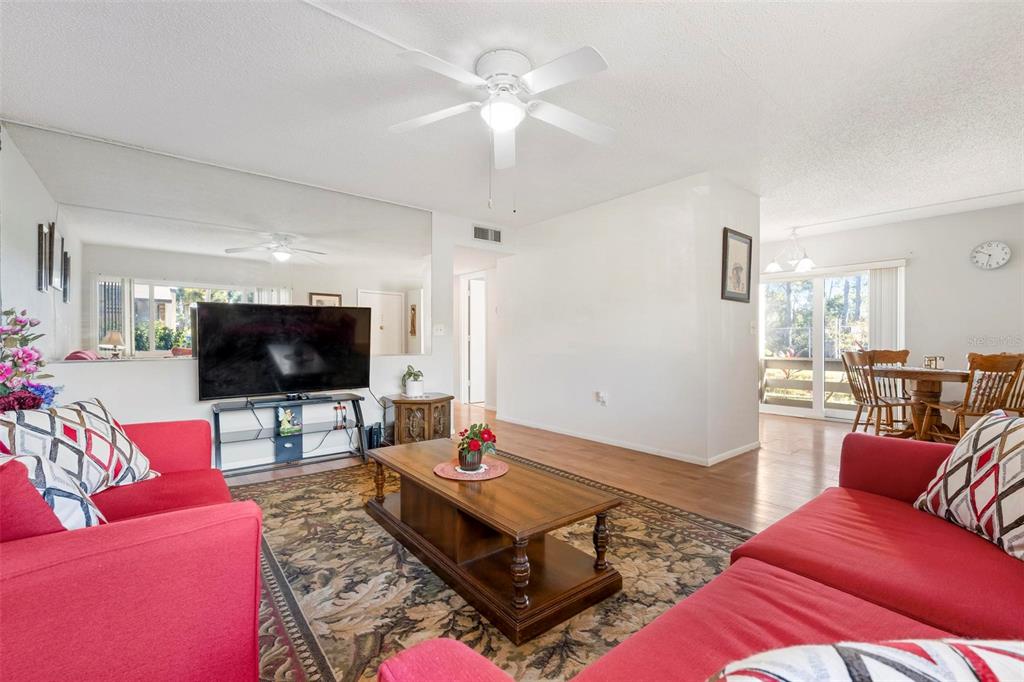 25 Quails Run Boulevard, Unit 6 Englewood, FL 34223 - Photo 10 of 31 a living room with furniture and a flat screen tv