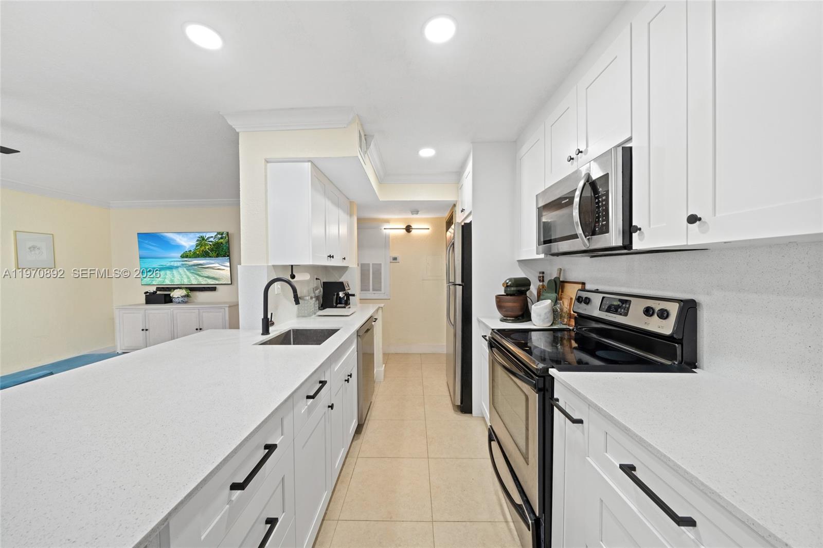 15599 Southwest 106th Lane, Unit 1209 Miami, FL 33196 - Photo 1 of 24 a kitchen with stainless steel appliances granite countertop a sink stove and refrigerator