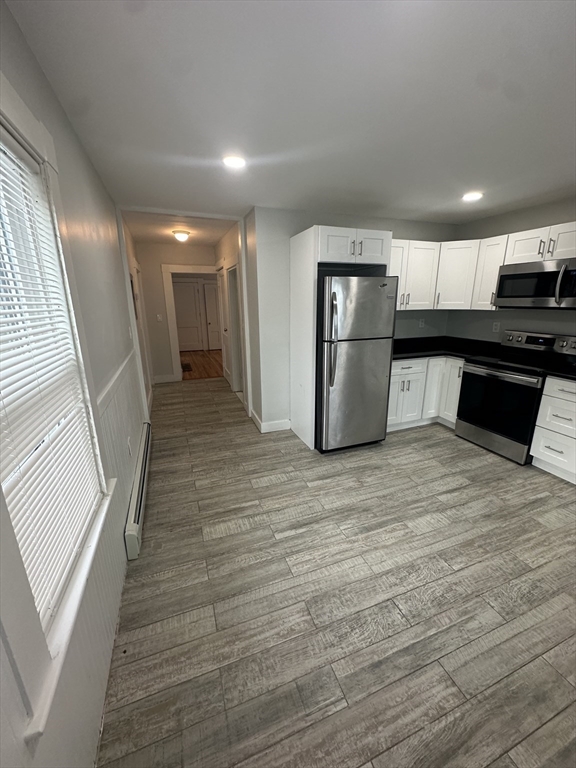 30 Clement Avenue, Unit 2 Peabody, MA 01960 - Photo 2 of 35 a view of a refrigerator in kitchen and wooden floor