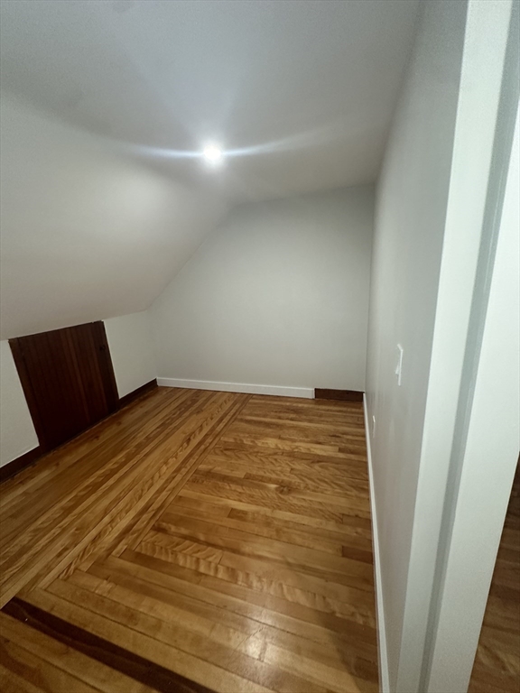30 Clement Avenue, Unit 2 Peabody, MA 01960 - Photo 26 of 35 a bedroom with a bed and wooden floor