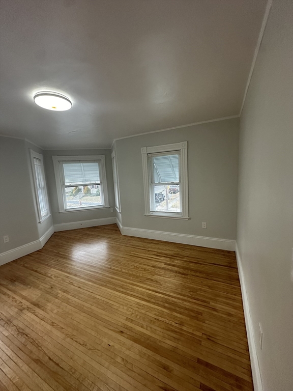 30 Clement Avenue, Unit 2 Peabody, MA 01960 - Photo 28 of 35 an empty room with wooden floor and windows