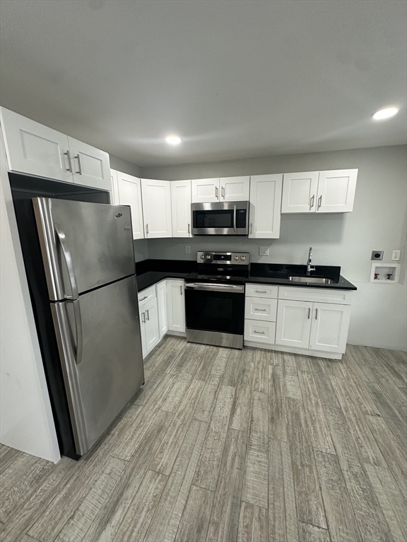 30 Clement Avenue, Unit 2 Peabody, MA 01960 - Photo 3 of 35 a kitchen with stainless steel appliances a refrigerator sink and microwave