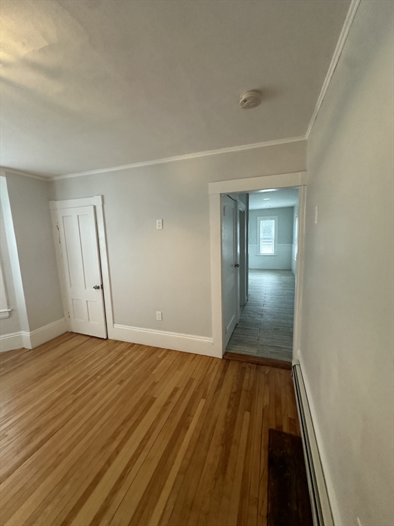 30 Clement Avenue, Unit 2 Peabody, MA 01960 - Photo 32 of 35 a view of an empty room with wooden floor and a window