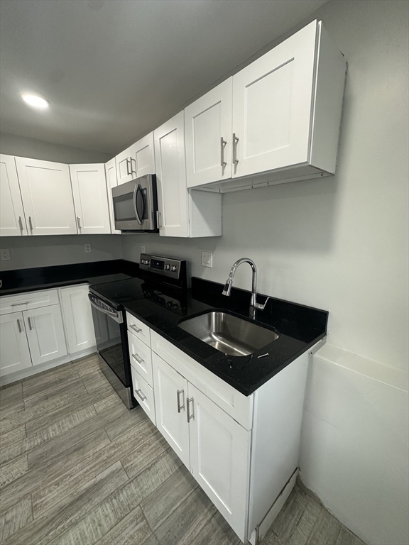 30 Clement Avenue, Unit 2 Peabody, MA 01960 - Photo 6 of 35 a kitchen with stainless steel appliances granite countertop a sink stove and cabinets