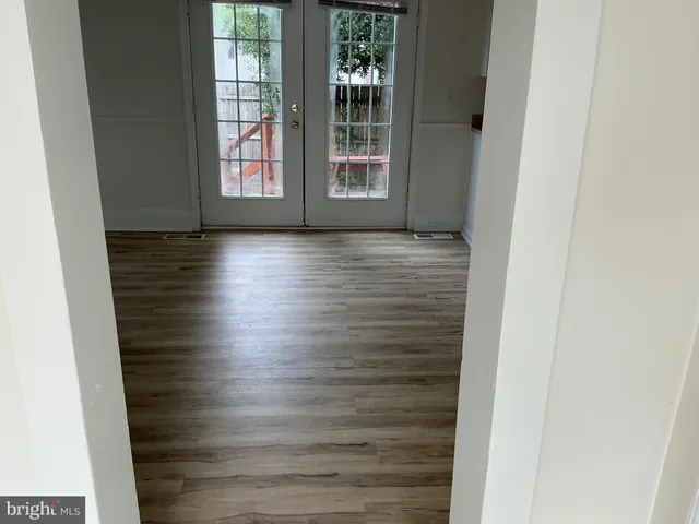 a view of wooden floor and windows in a room