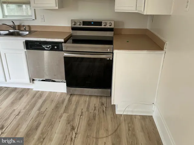 a view of room with wooden floor