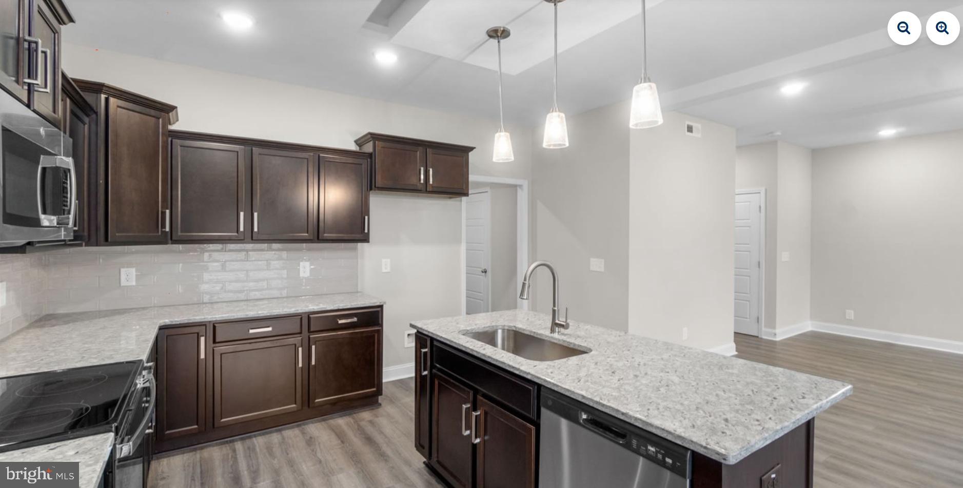 9911 Ridge Street Lanham, MD 20706 - Photo 2 of 10 a kitchen with stainless steel appliances granite countertop a sink stove and refrigerator