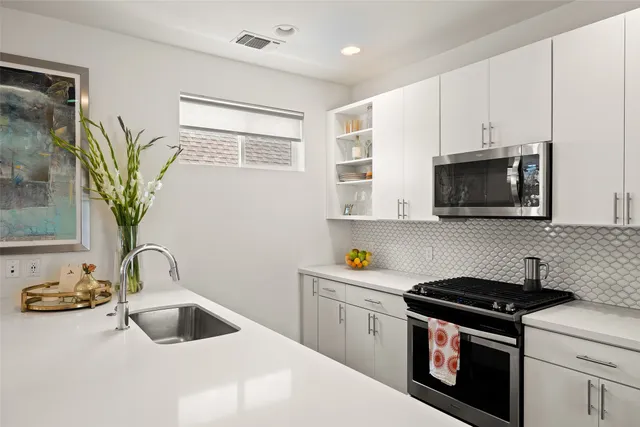a kitchen with a sink stove and microwave