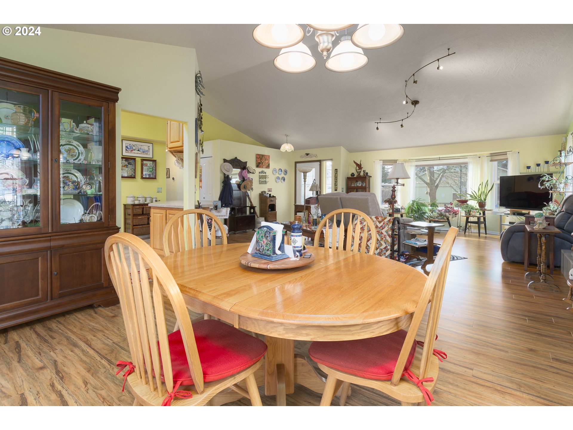 2969 Brett Loop Eugene, OR 97404 - Photo 13 of 33 a view of a dining room with furniture a chandelier and wooden floor