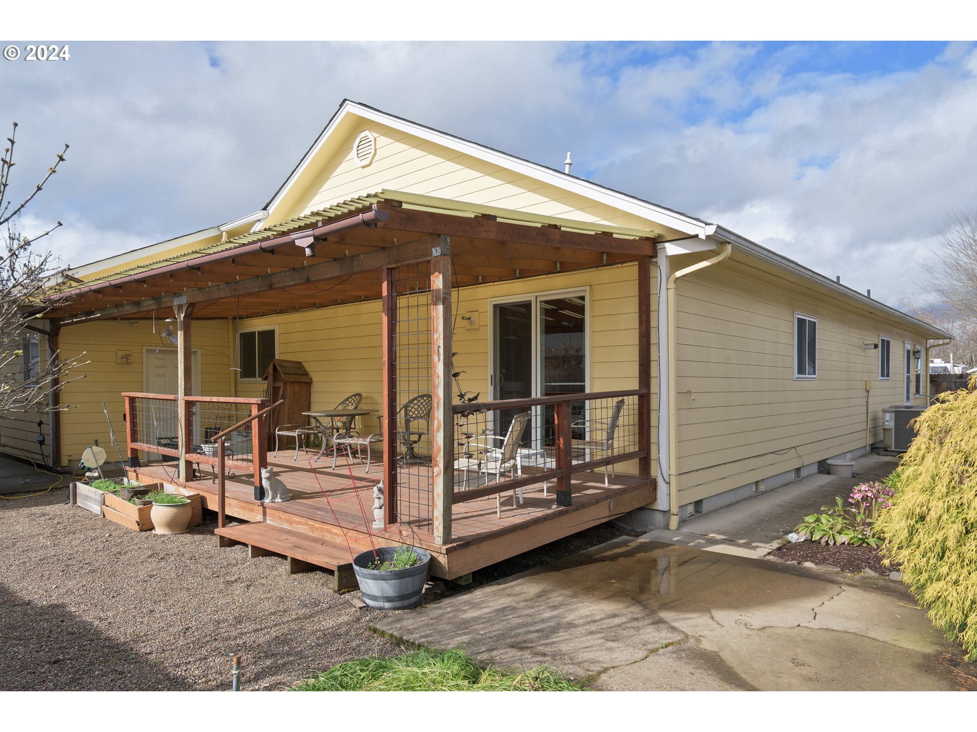 2969 Brett Loop Eugene, OR 97404 - Photo 28 of 33 a backyard of a house with barbeque oven table and chairs