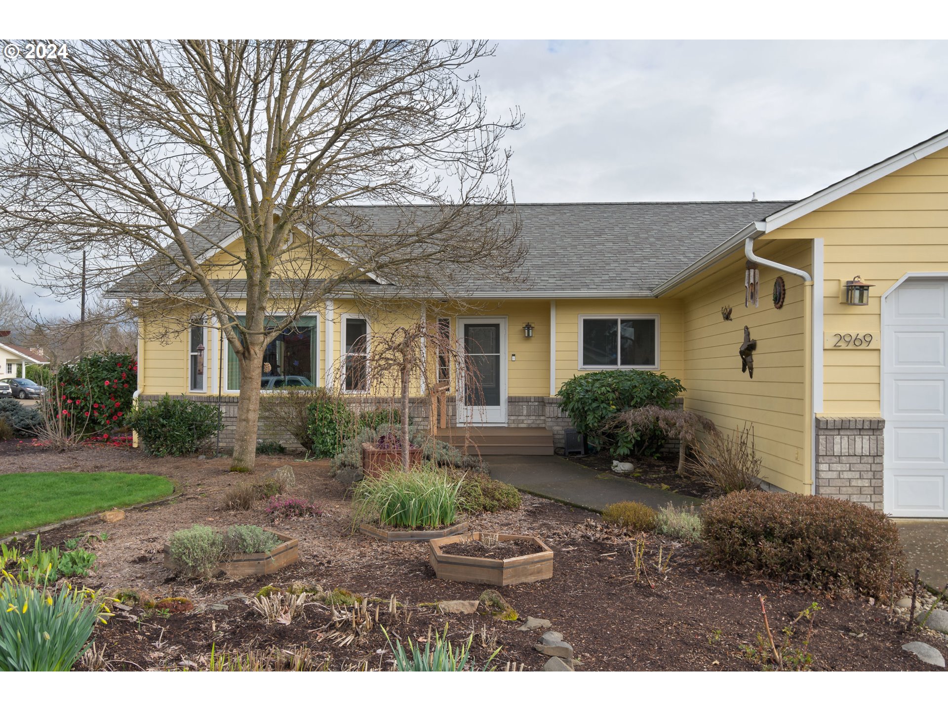 2969 Brett Loop Eugene, OR 97404 - Photo 5 of 33 a front view of a house with a yard and potted plants