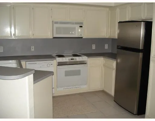 a kitchen with a stove sink and refrigerator