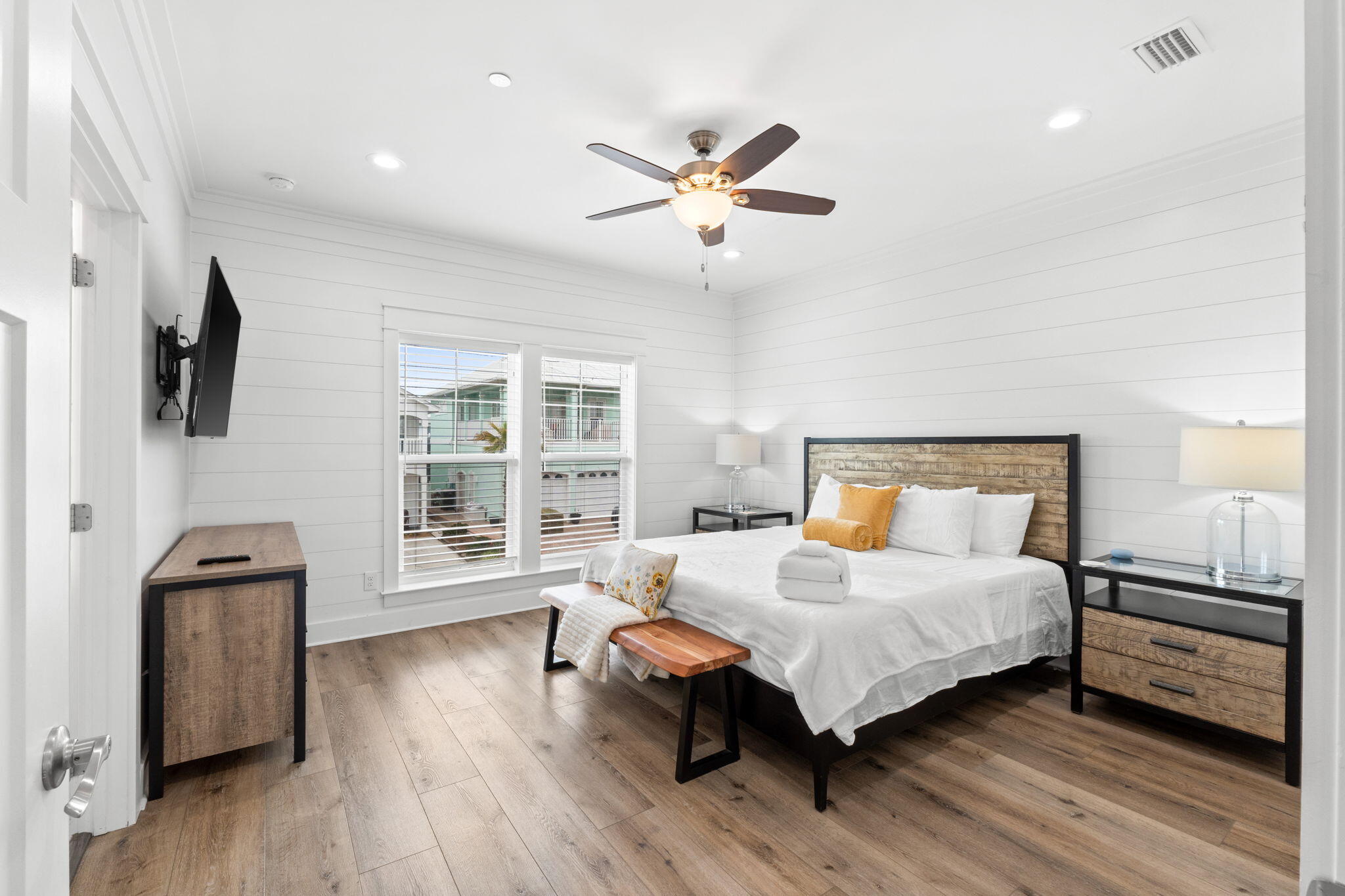 116 Riviera Drive Panama City Beach, FL 32413 - Photo 31 of 66 a bedroom with a bed and wooden floor