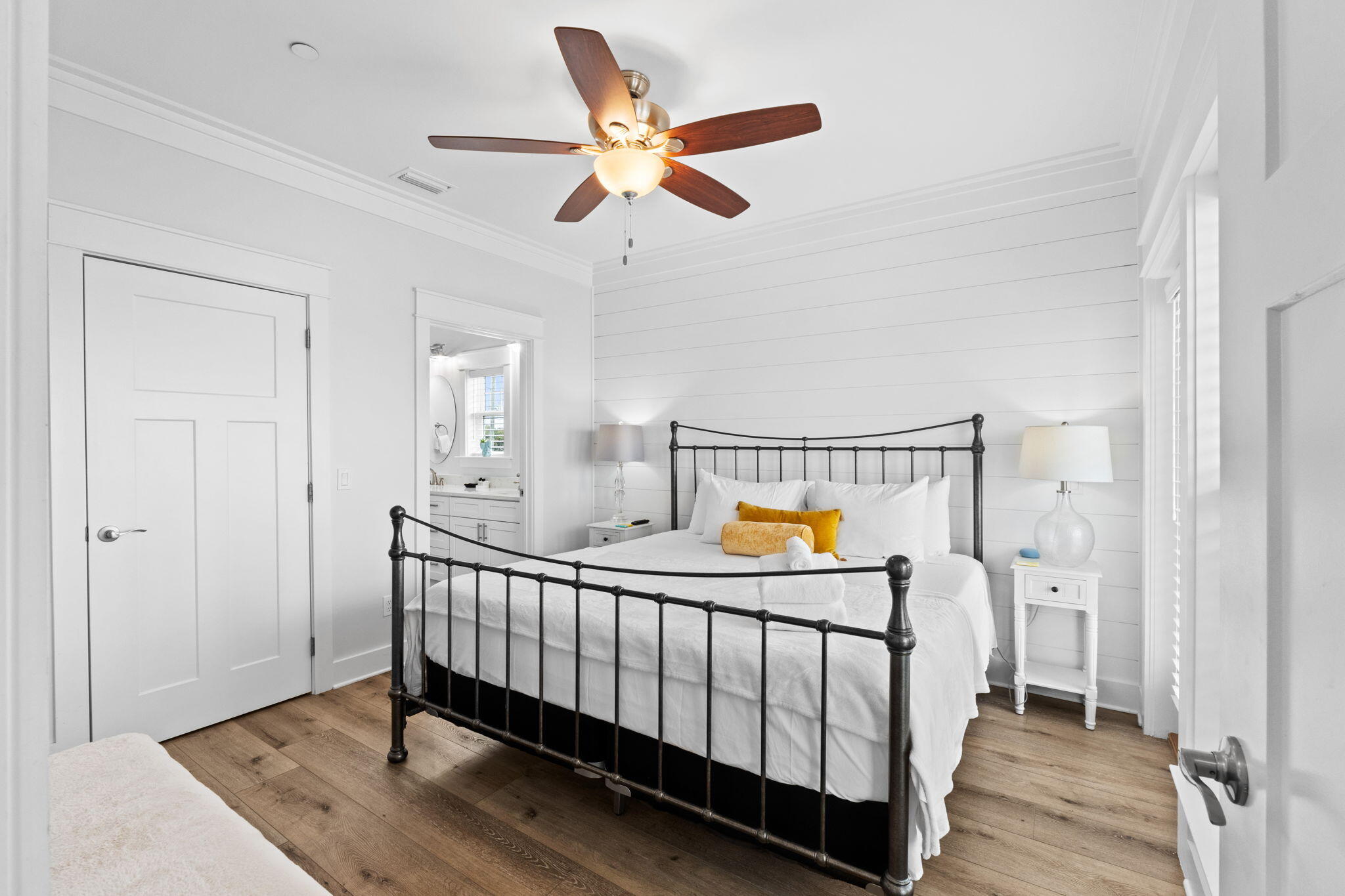 116 Riviera Drive Panama City Beach, FL 32413 - Photo 51 of 66 a bedroom with a bed and wooden floor