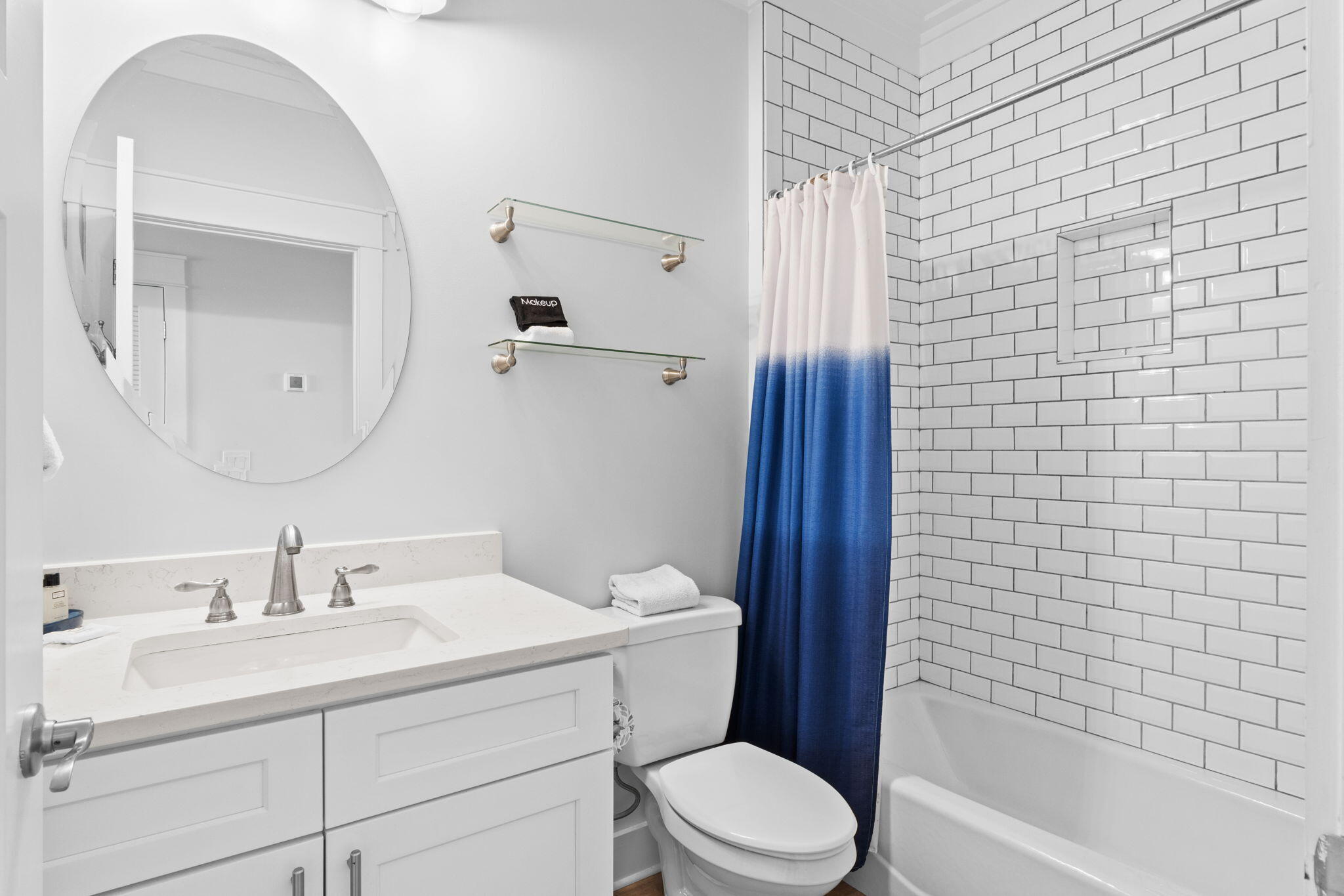 116 Riviera Drive Panama City Beach, FL 32413 - Photo 55 of 66 a bathroom with a toilet a sink a mirror a bathtub and shower