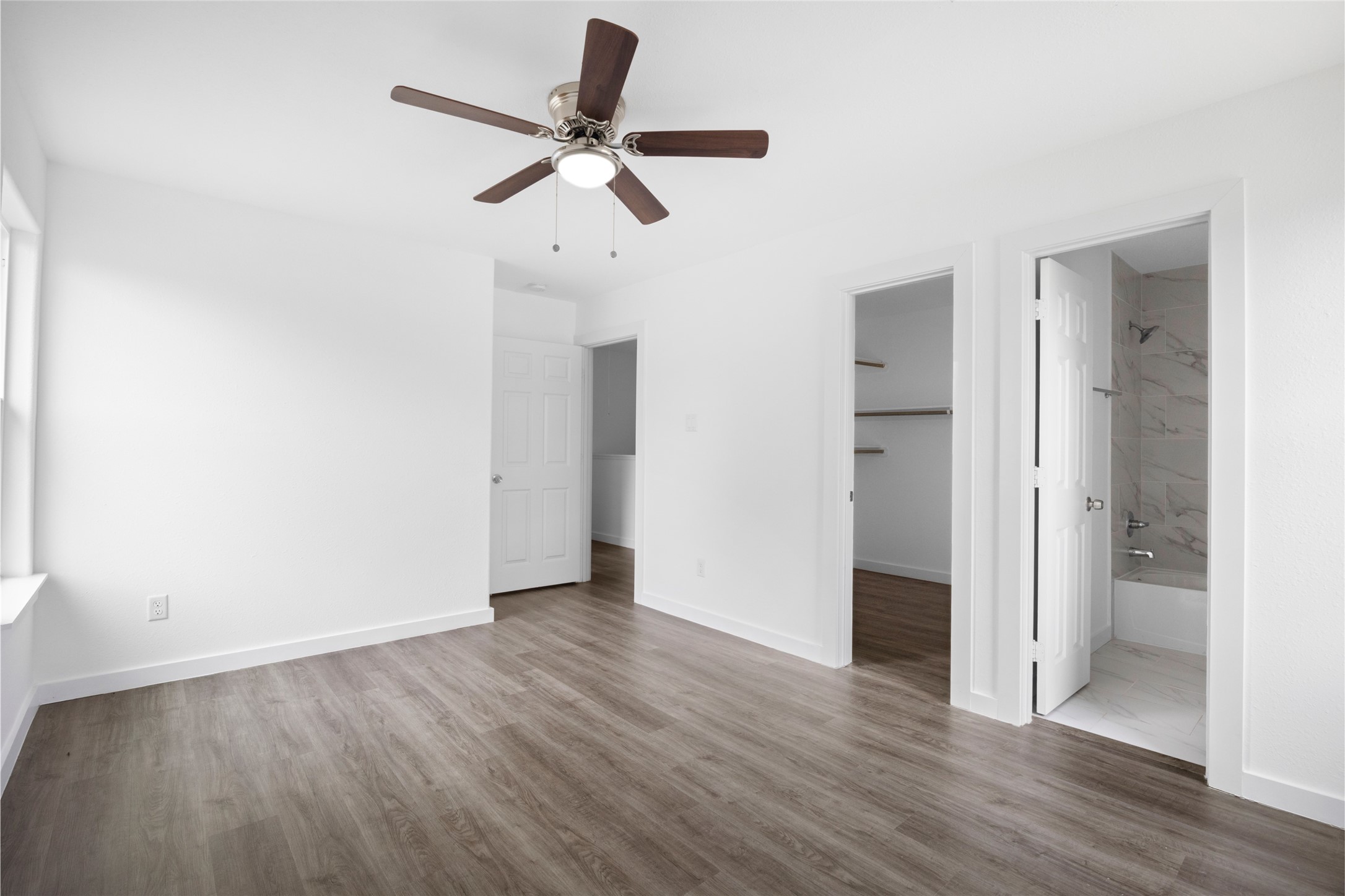 9243 Seeker Street Houston, TX 77028 - Photo 14 of 22 an empty room to hallway with wooden floor