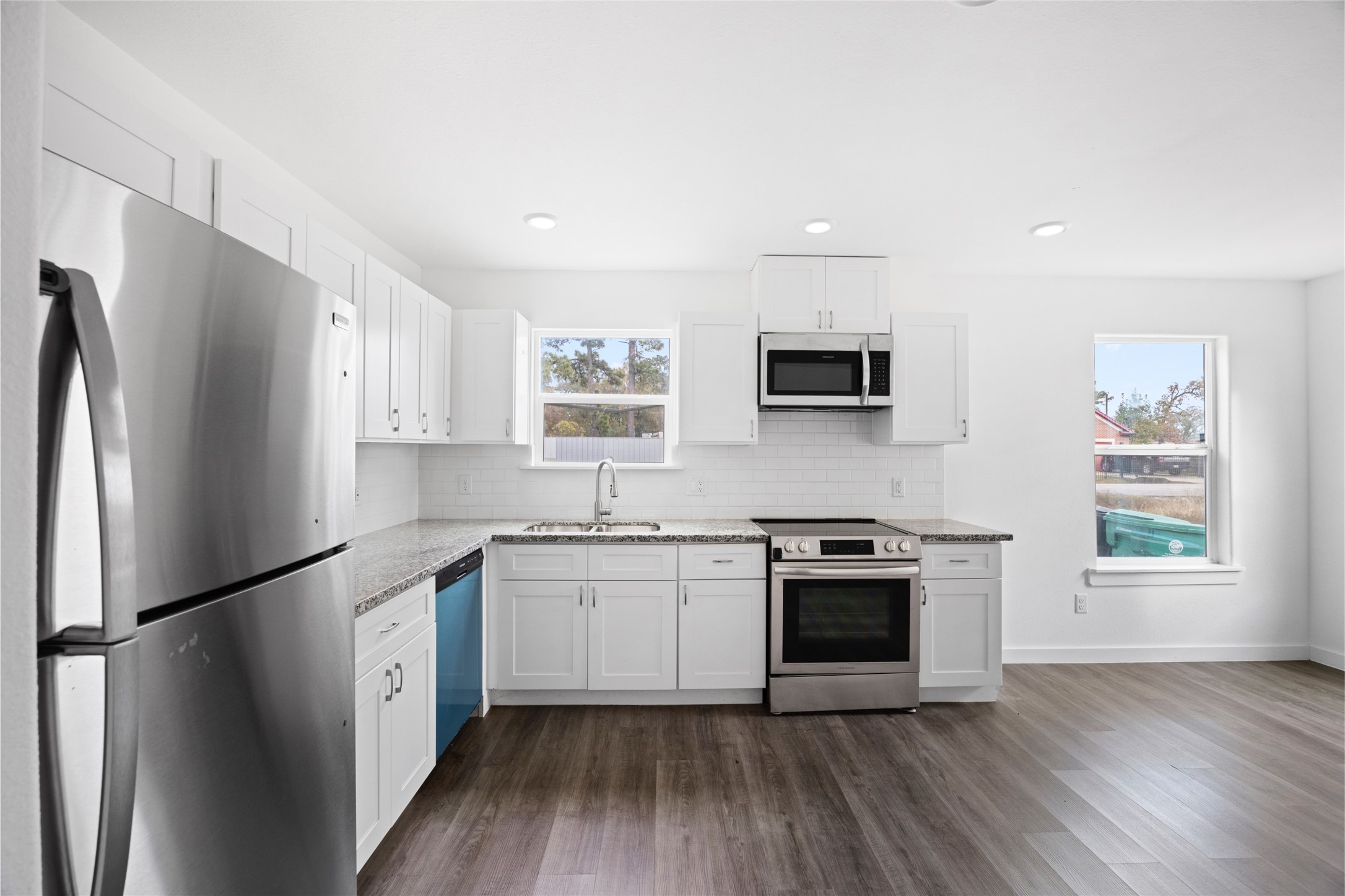 9243 Seeker Street Houston, TX 77028 - Photo 4 of 22 a kitchen with stainless steel appliances a refrigerator sink and microwave