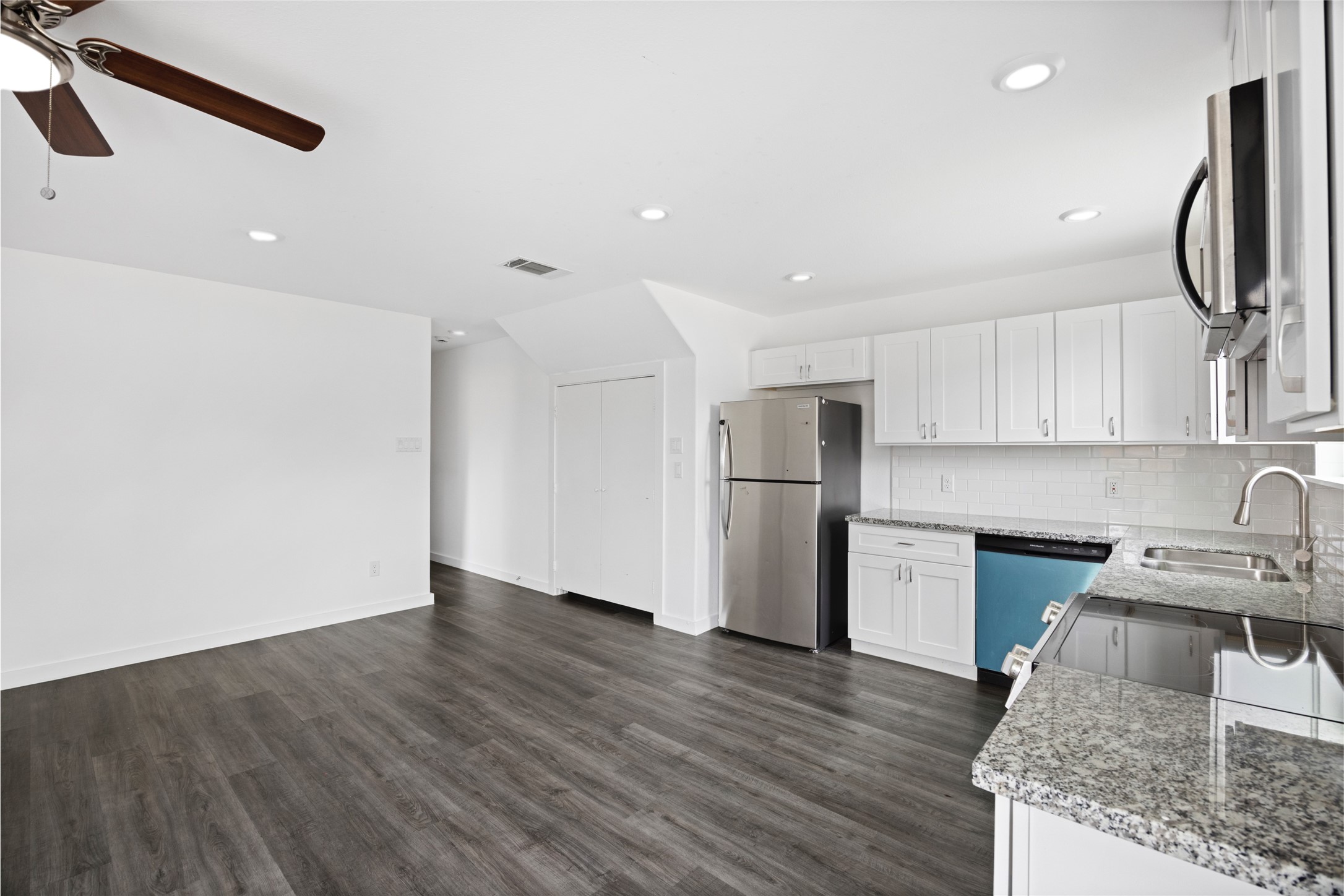 9243 Seeker Street Houston, TX 77028 - Photo 6 of 22 a kitchen with granite countertop a sink cabinets and stainless steel appliances