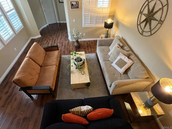 a living room with furniture and a mirror