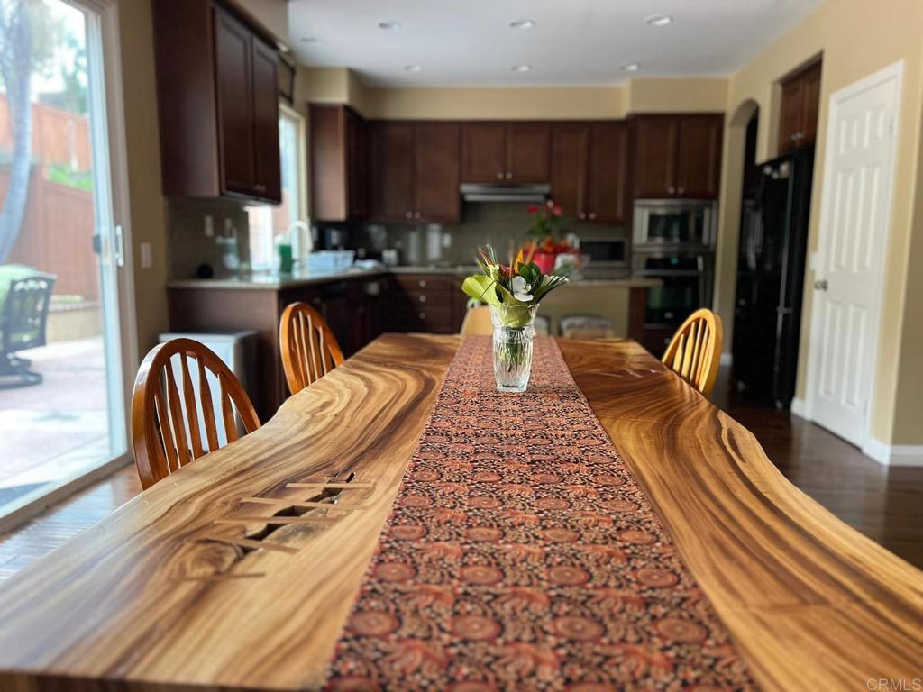 2436 Crooked Trail Road Chula Vista, CA 91914 - Photo 12 of 47 a view of a dining room with furniture a rug and wooden floor