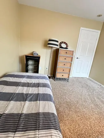 a bedroom with a bed and a chair