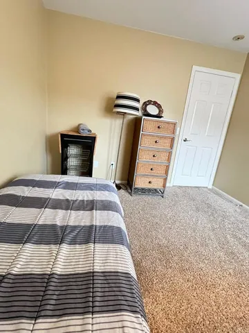 a bedroom with a bed and a chair