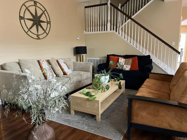 a living room with furniture a rug and a chandelier