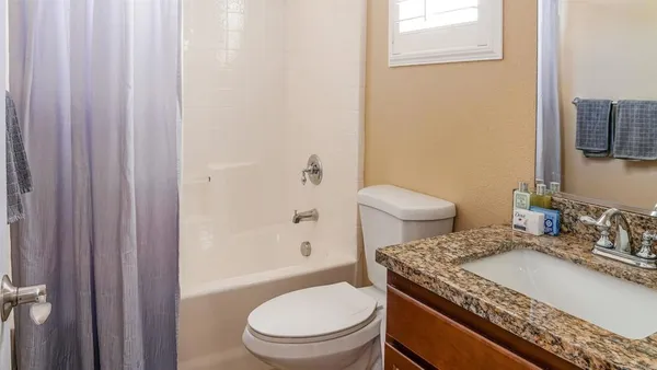 a bathroom with sinks granite countertop and a sink