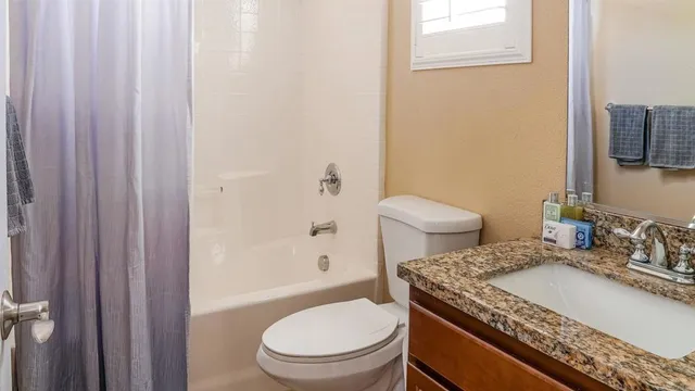a bathroom with sinks granite countertop and a sink