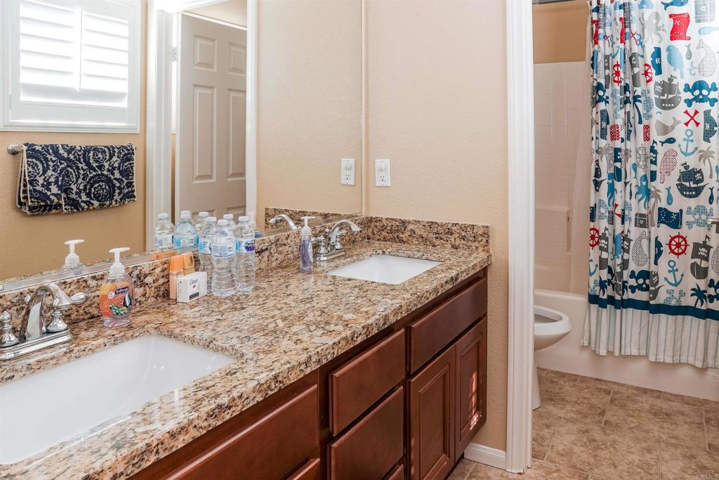 2436 Crooked Trail Road Chula Vista, CA 91914 - Photo 26 of 47 a bathroom with sinks granite countertop and a sink